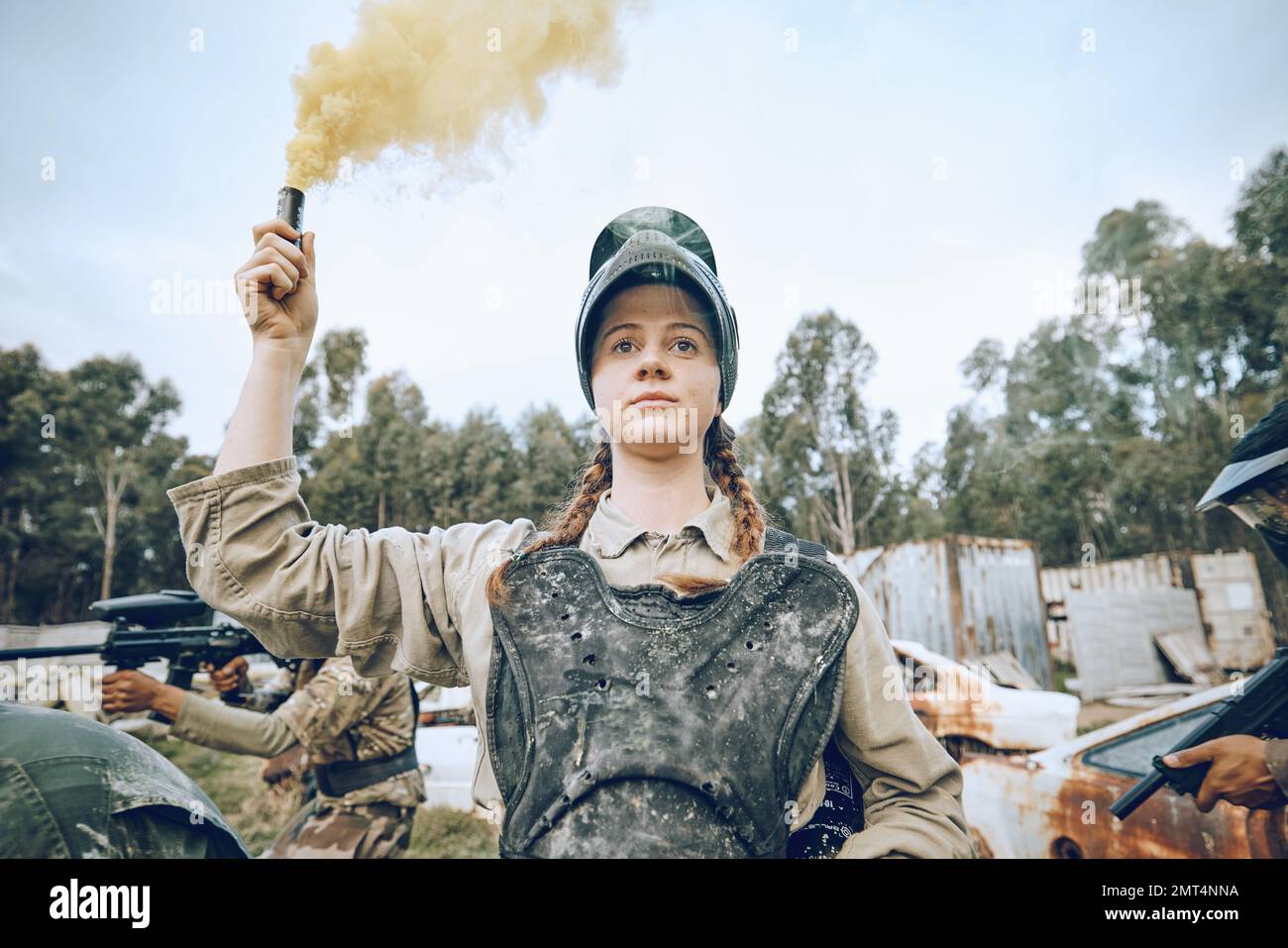 Nature, battle and girl with smoke during paintball, military training and army game in Spain. War, alert and woman playing with gear and equipment Stock Photo