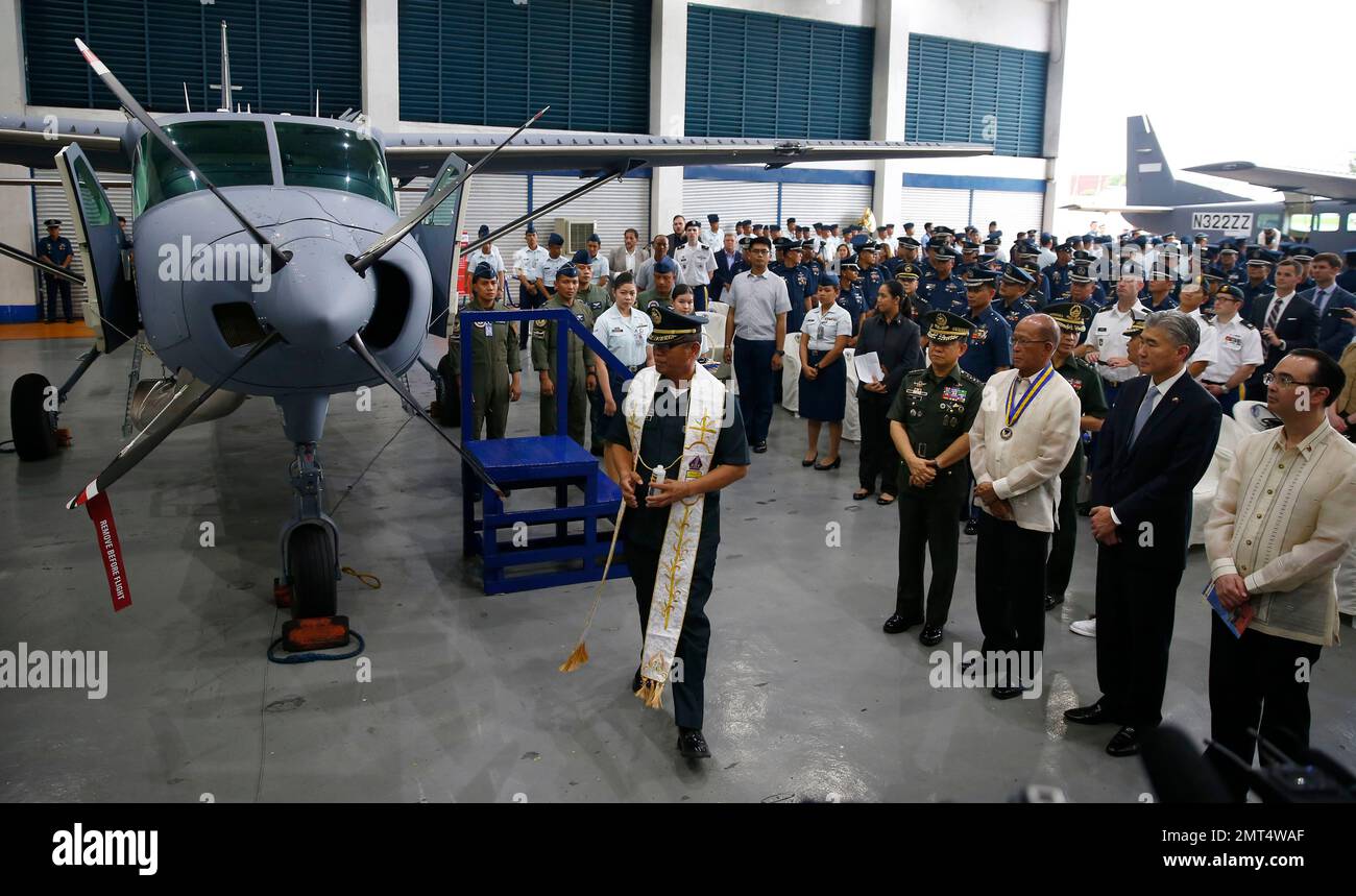 A military chaplain blesses two new Cessna 208B Caravan aircrafts which