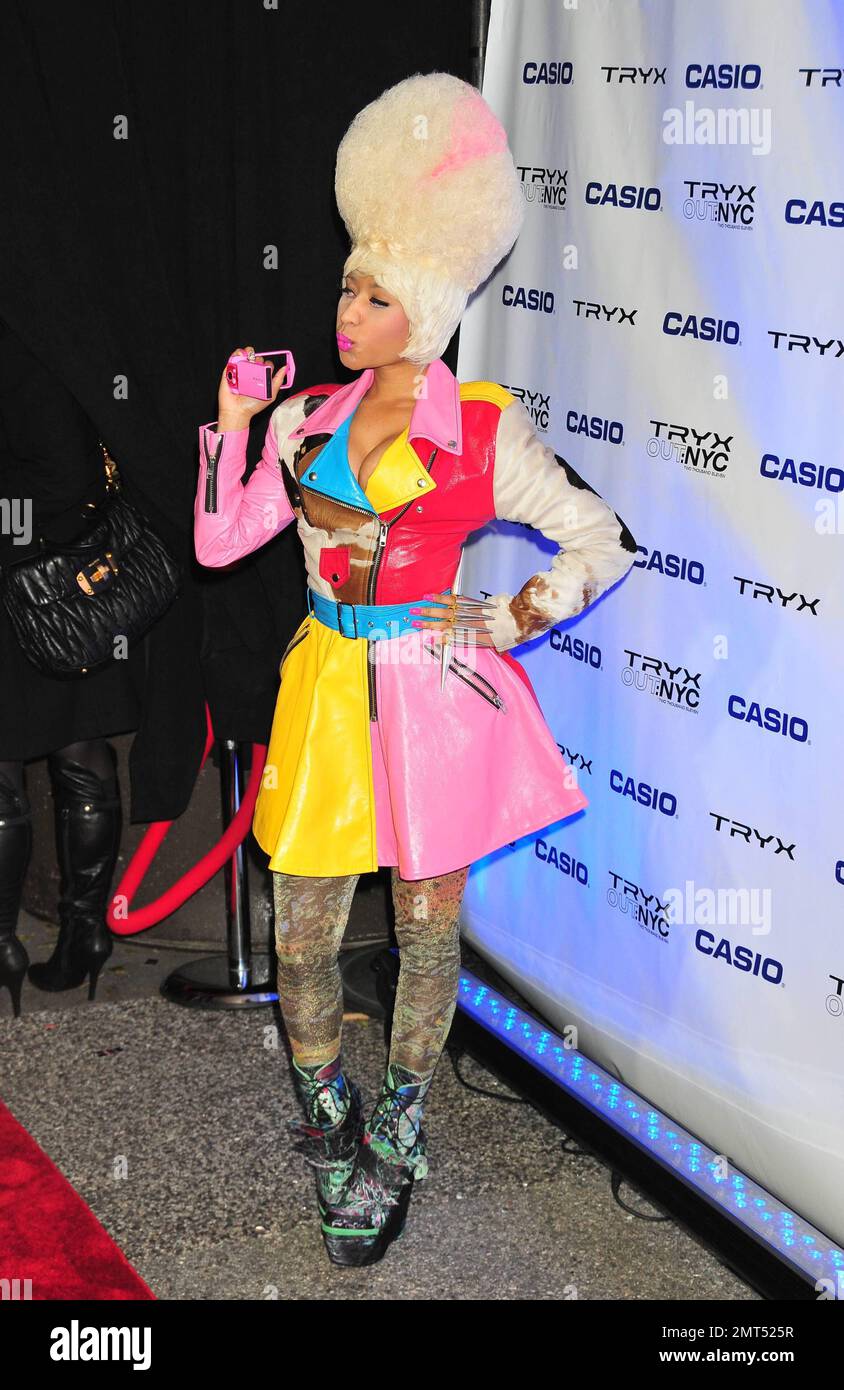 Hip hop and R&B singer Nicki Minaj wears a wild outfit of a bust-enhancing  multicolor leather and fur jacket that doubled as a dress paired with a one  of her trademark wigs