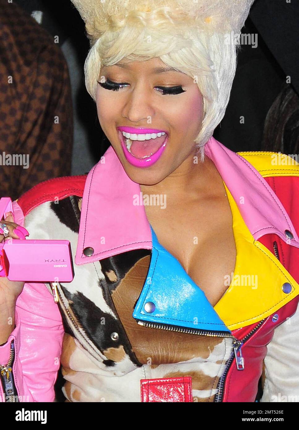 Hip hop and R&B singer Nicki Minaj wears a wild outfit of a bust-enhancing  multicolor leather and fur jacket that doubled as a dress paired with a one  of her trademark wigs