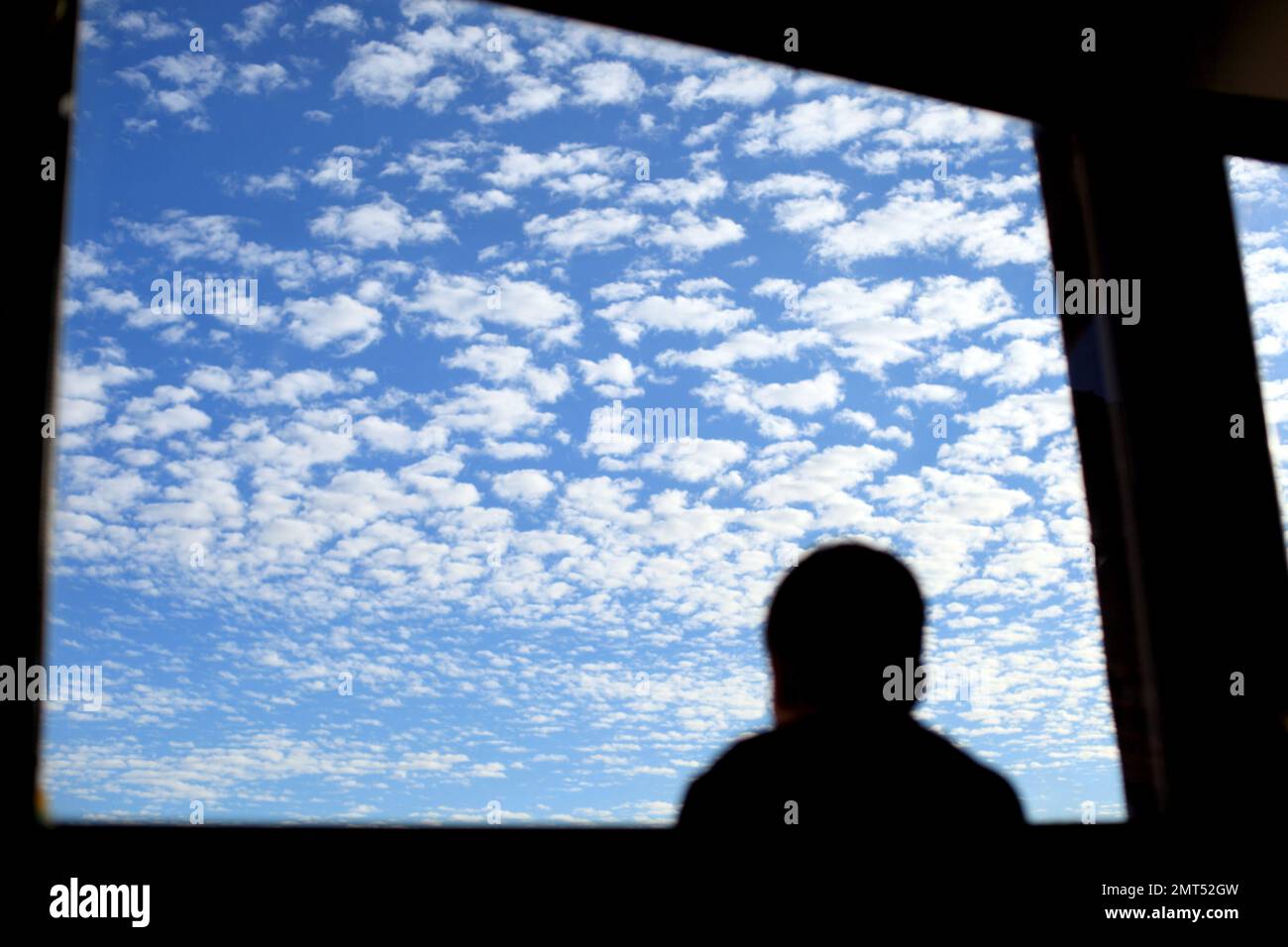 kids looking the sky with strange white clouds through the window , Alpes Maritimes, 06, Cote d'Azur, France Stock Photo