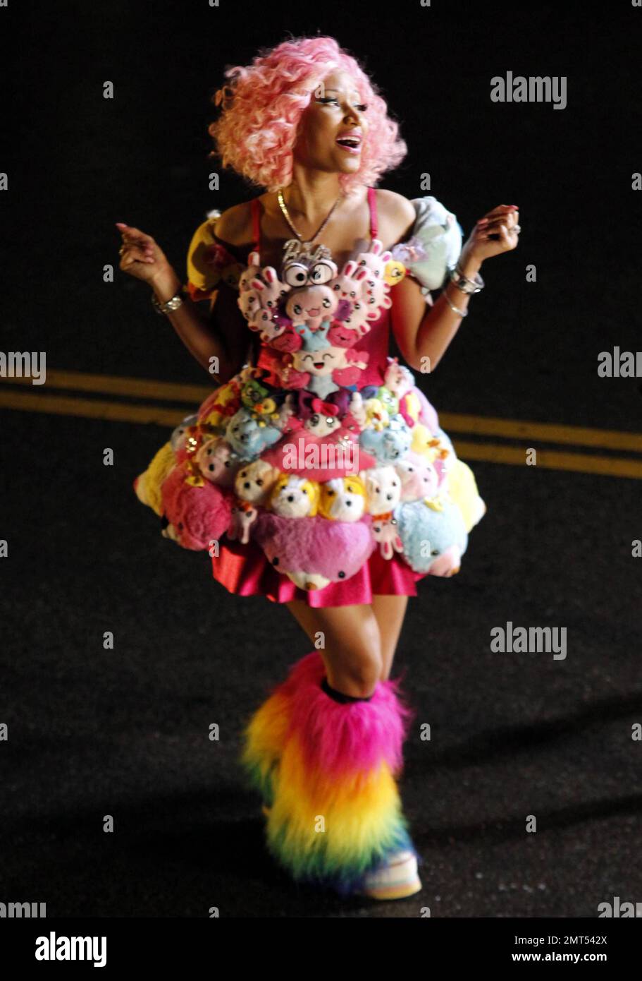 Wearing a pink wig, a stuffed animalcovered dress and rainbowcolored