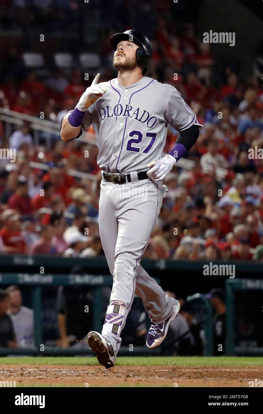 Colorado Rockies' Trevor Story looks skyward as he arrives home after  hitting a solo home run during the eighth inning of the team's baseball  game against the St. Louis Cardinals on Tuesday