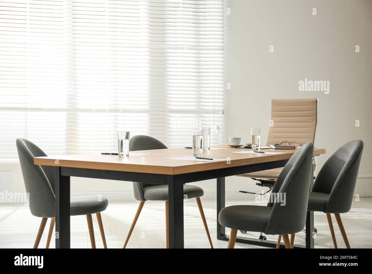 Simple office interior with large table and chairs Stock Photo - Alamy