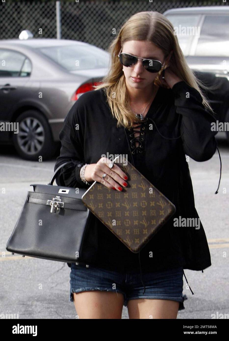 Carrying along her iPad in a luxurious Louis Vuitton sleeve, Nicky