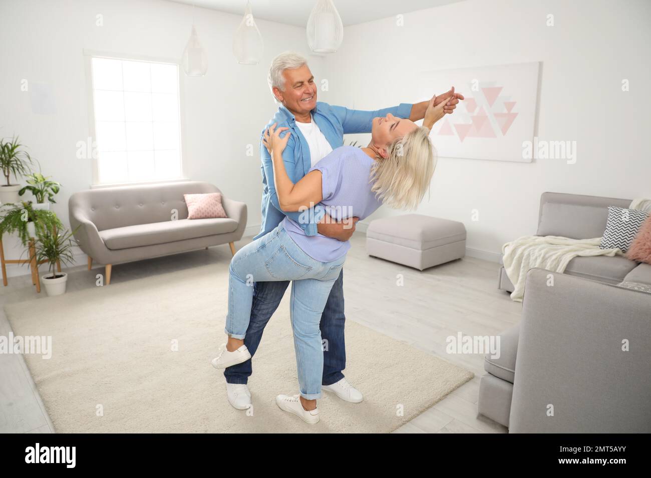 Grandmother dancing in living room hi-res stock photography and images ...