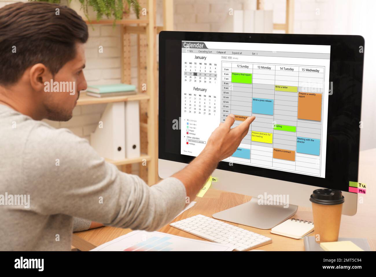 Handsome man using calendar hi-res stock photography and images - Alamy