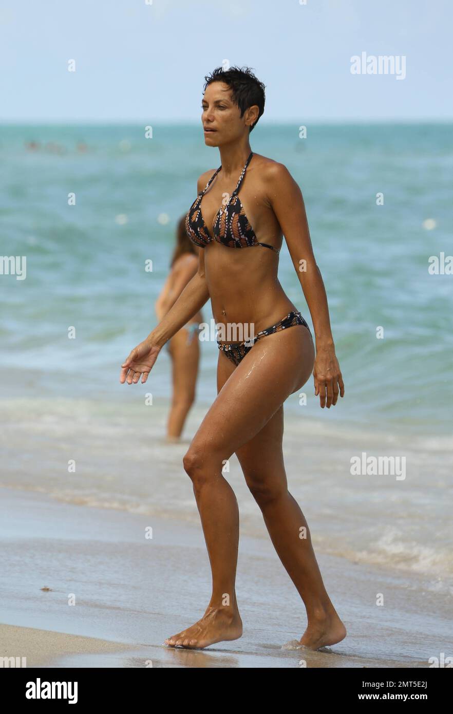Newly single Nicole Murphy shows off her incredible bikini body during  Labour Day in South Beach. Murphy was accompanied by a tattooed hunk and  female friend. She's been in town promotion her