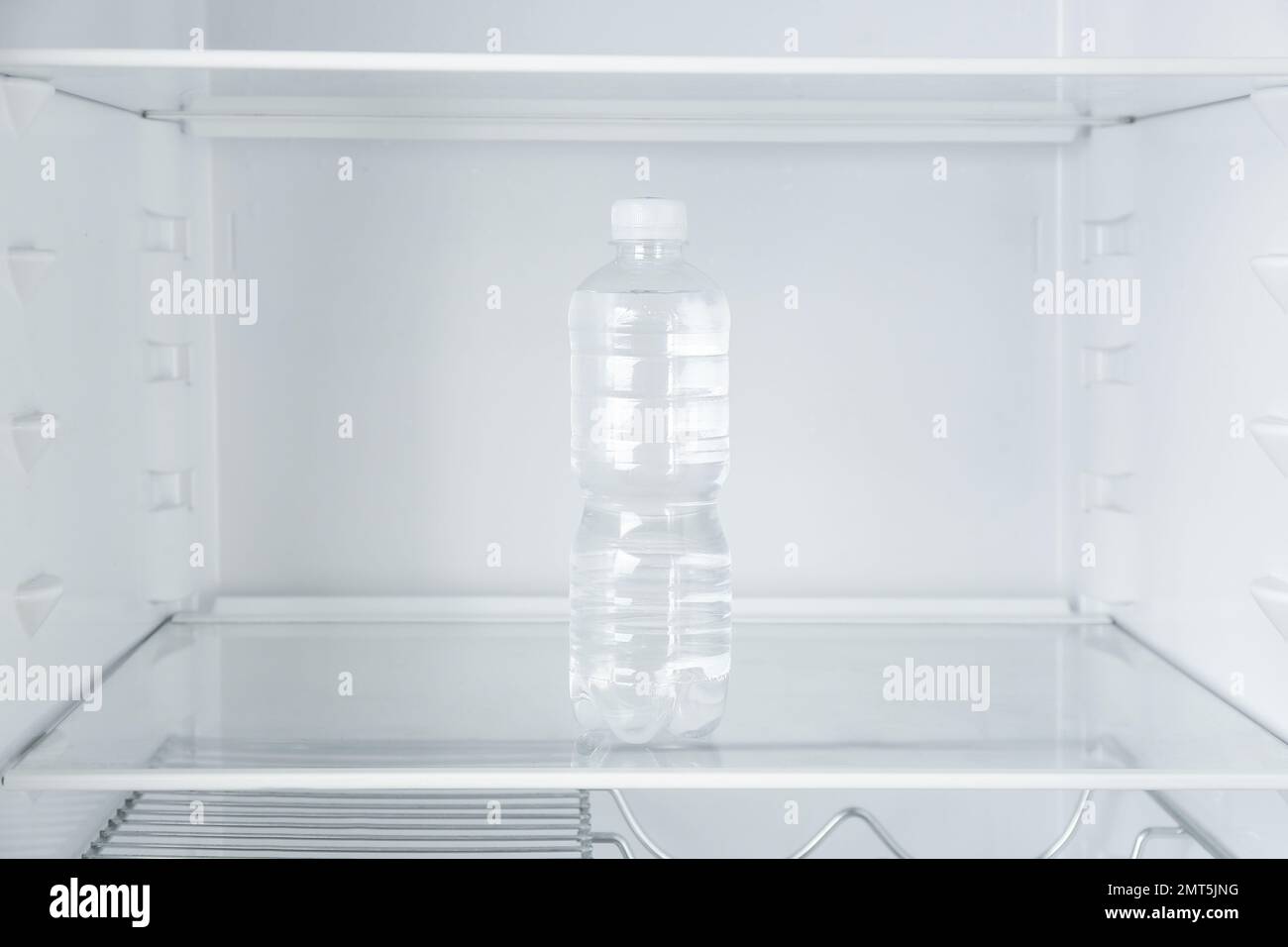 Glass water bottle in refrigerator hi-res stock photography and