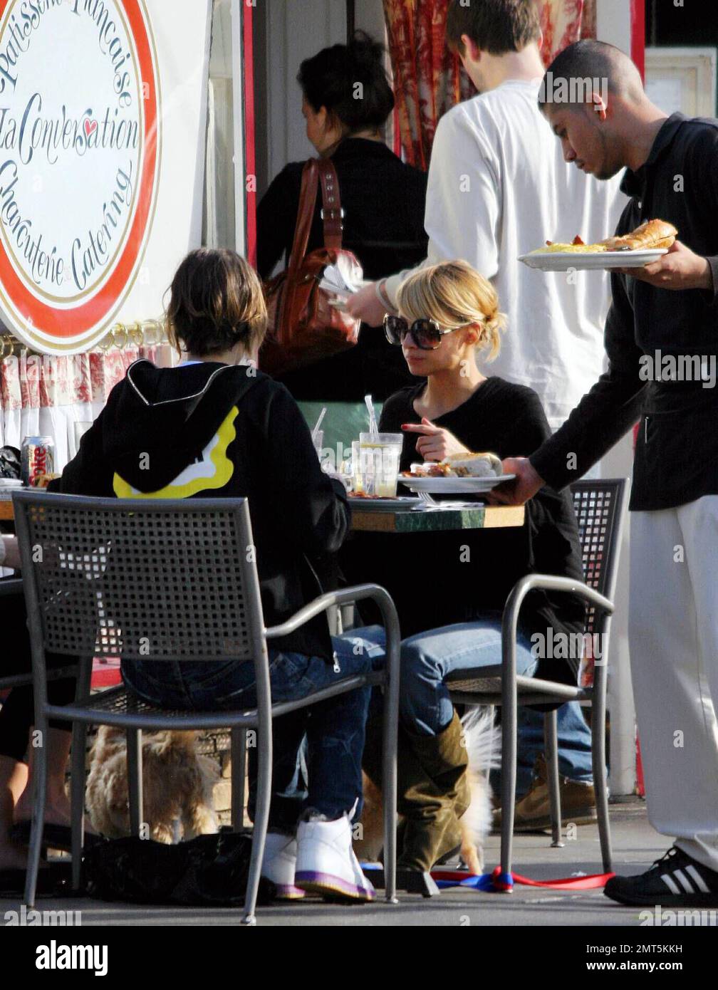 Exclusive!! Nicole Richie takes her two dogs Foxy Cleopatra and Honey Child along for lunch with her friends at La Conversacion in Beverly Hills, Ca. Richie spent most of the meal fussing over her two pooches, petting and feeding them. 1/29/06 Stock Photo