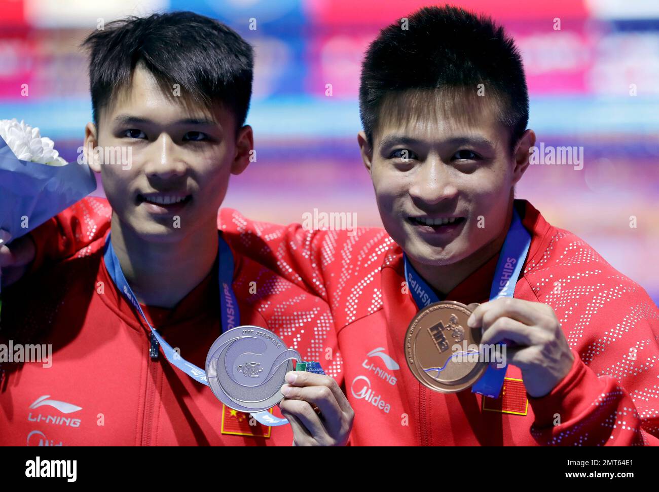 China's silver medalist Chen Aisen, left, and his teammate and bronze