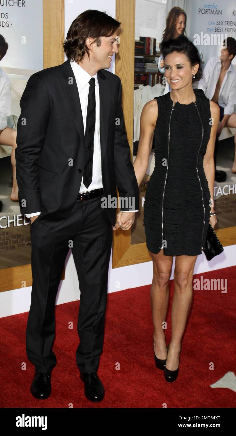 Husband and wife Ashton Kutcher, 32, and Demi Moore, 48, hold hands on the red carpet at the premiere of picture