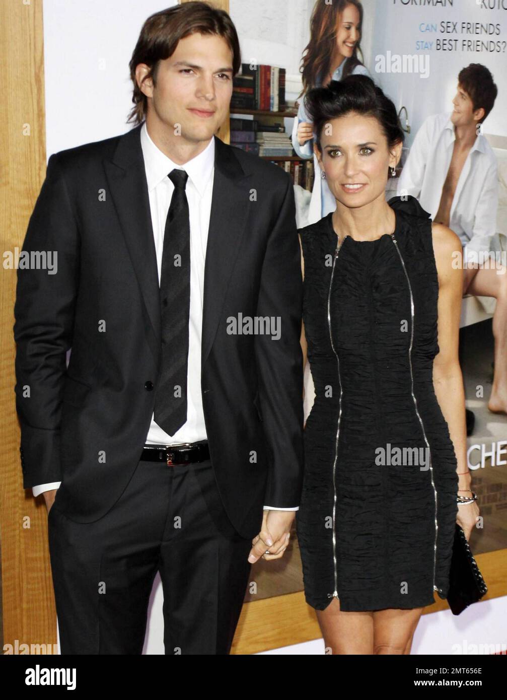 Husband and wife Ashton Kutcher, 32, and Demi Moore, 48, hold hands on the  red carpet at the premiere of 