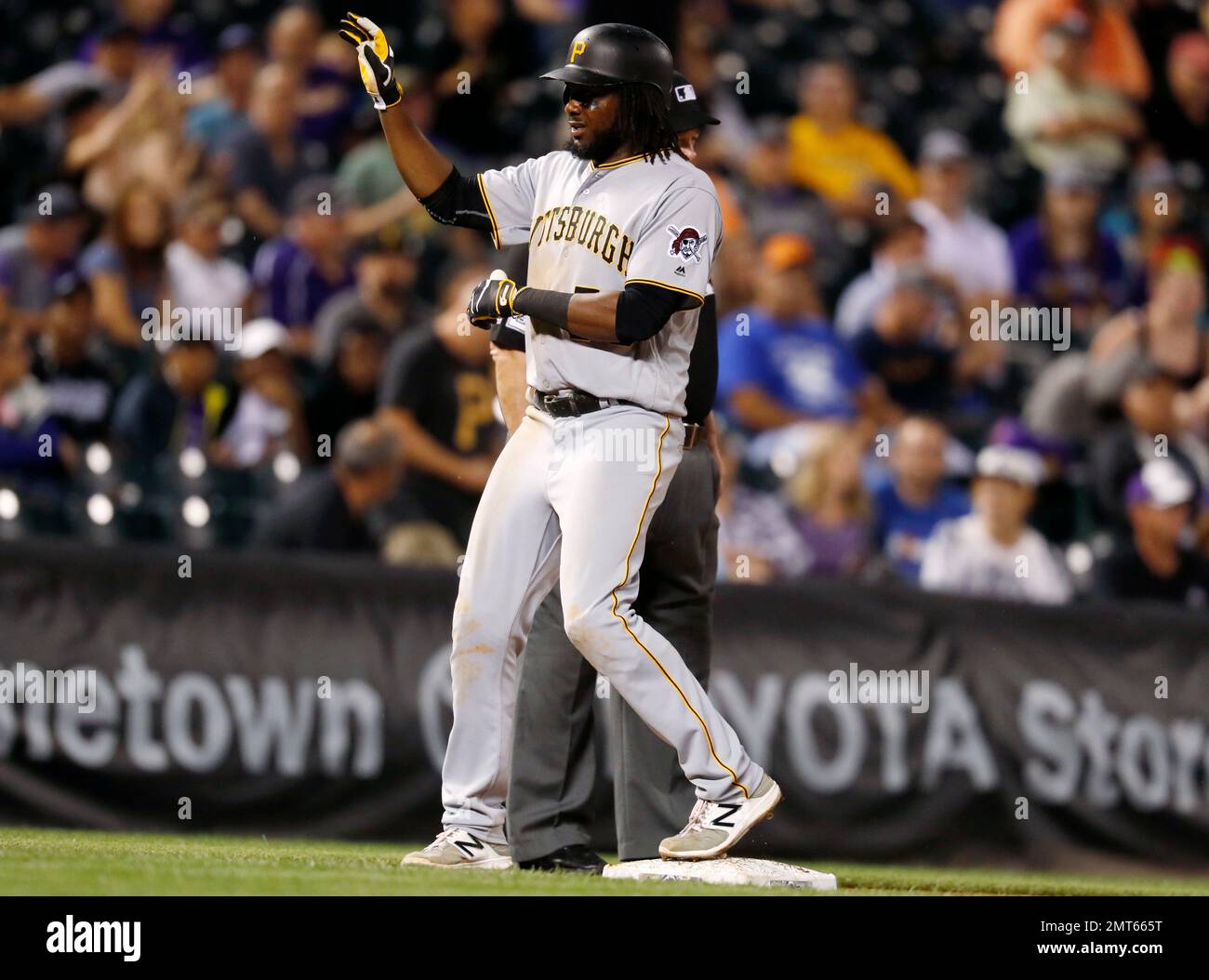 Pittsburgh Pirates' Josh Bell pulls off his batting gloves as he stands on  second base after driving in two runs with a double off Chicago White Sox  starting pitcher Reynaldo Lopez in