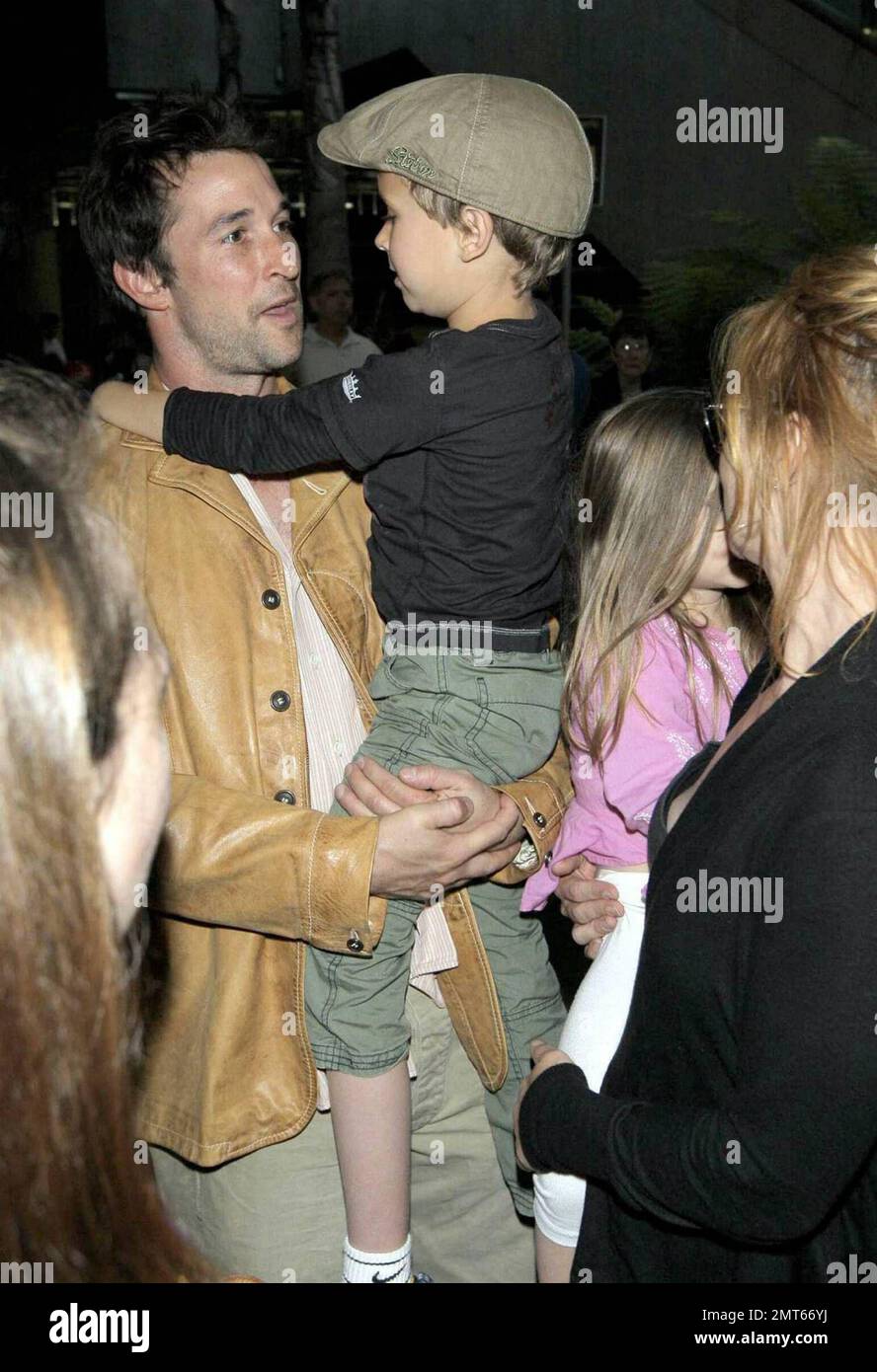 'ER' star Noah Wylie and family arrive stateside at Los Angeles International Airport after a family European vacation. Noah and his wife Tracy Warbin, carried thier children, daughter Auden and son Owen Strausser through the airport as they were assisted with their luggage. The kids looked tired after the long flight. Los Angeles, CA. 4/29/09.   . Stock Photo