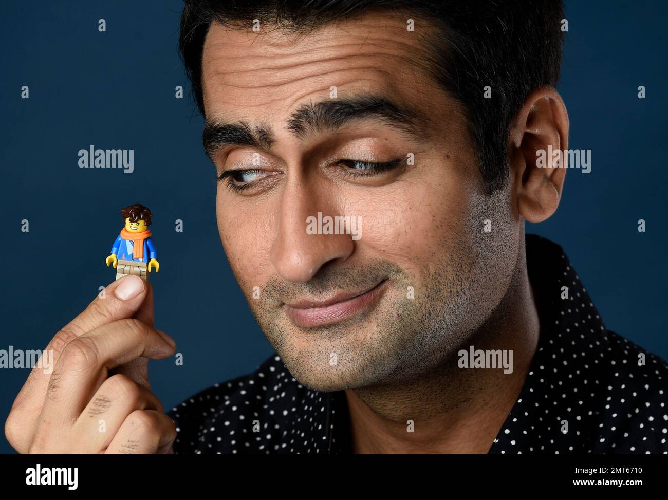 Kumail Nanjiani holds his Lego figurine as he poses for a portrait to promote the film The LEGO Ninjago Movie on day two of Comic Con International on Friday July 21 2017 in