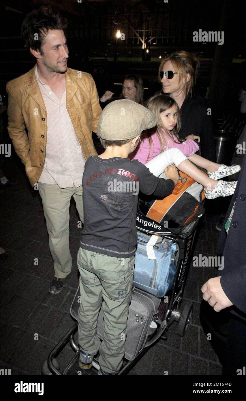 'ER' star Noah Wylie and family arrive stateside at Los Angeles International Airport after a family European vacation. Noah and his wife Tracy Warbin, carried thier children, daughter Auden and son Owen Strausser through the airport as they were assisted with their luggage. The kids looked tired after the long flight. Los Angeles, CA. 4/29/09. Stock Photo