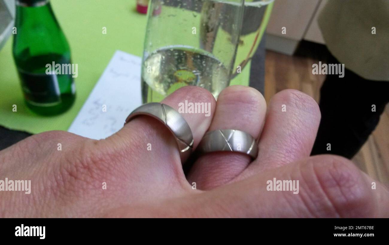 two hands clasped together with wedding rings after the wedding Stock Photo