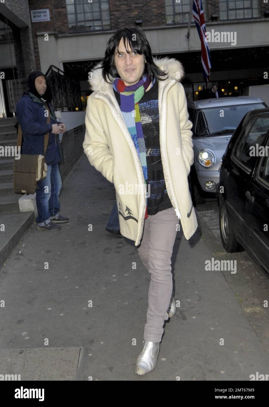 Noel Fielding wears a white coat, patterned sweater and striped scarf while out and about in London, UK. 14th December 2011. Stock Photo