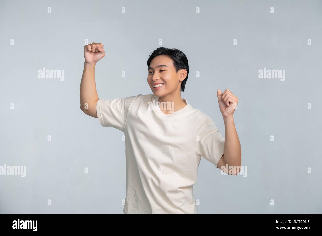 A portrait of happy excited young Asian man isolated on white ...