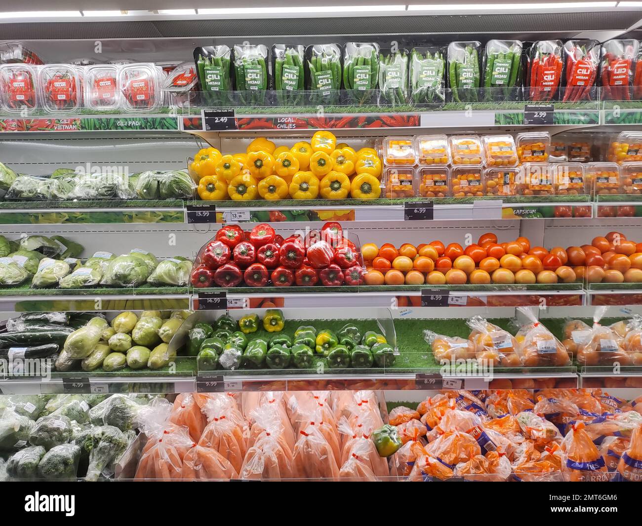 Various fresh vegetables on shelf in supermarket for background Stock