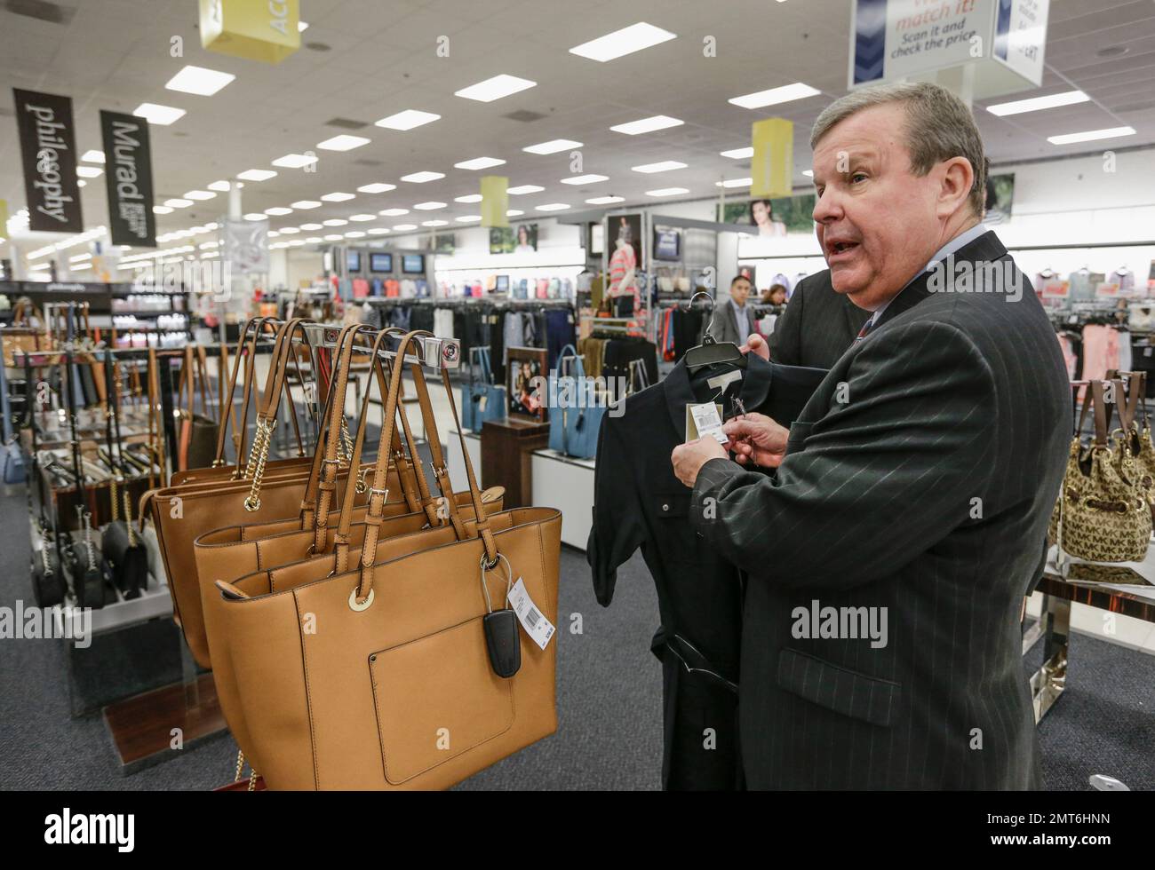 In this May 24, 2017, photo, Tom Shull, CEO of the Army & Air Force Exchange  Service, checks a price tag at a store inside the Exchange, at Offutt Air  Force Base