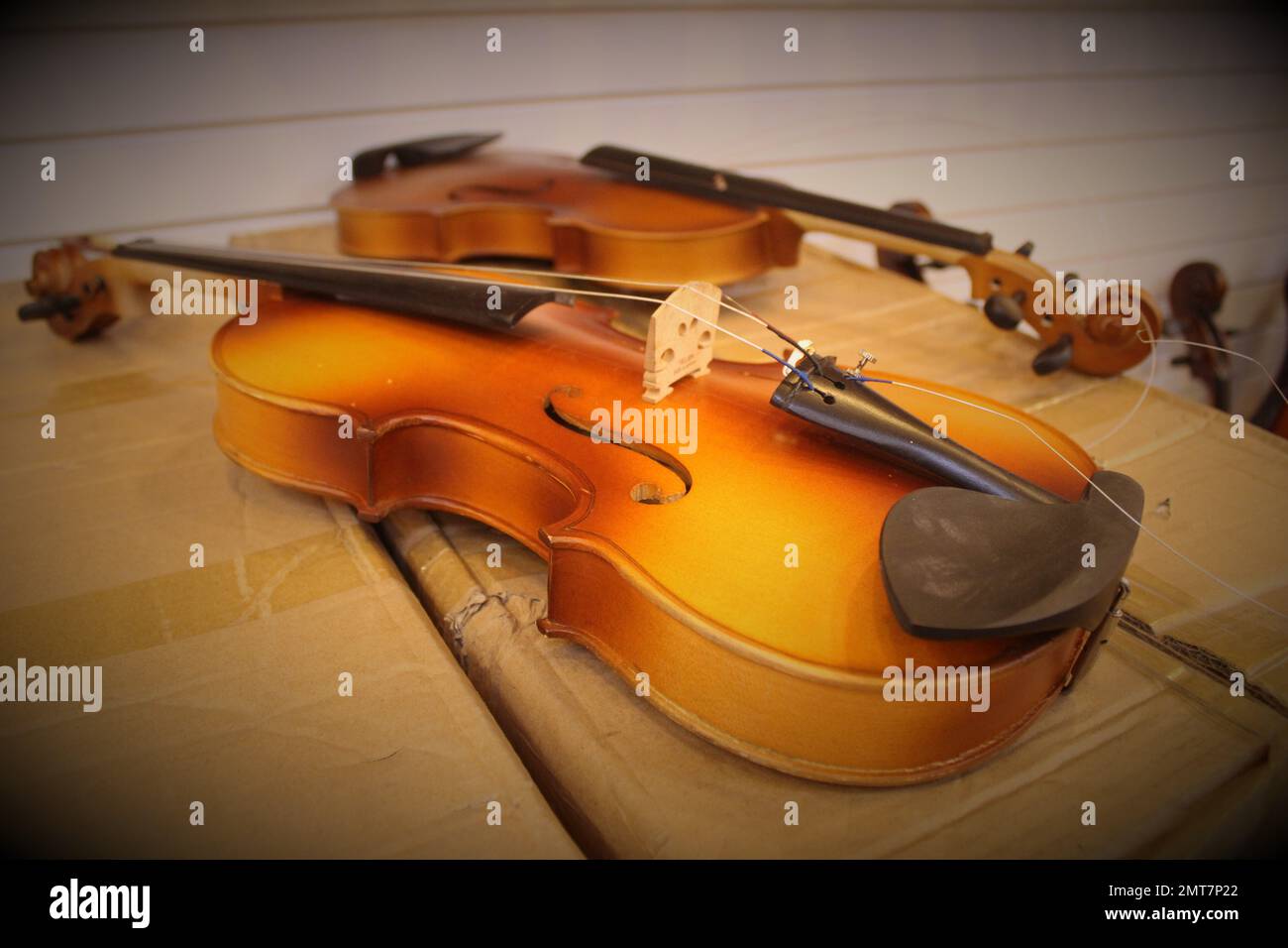 Violin in repair, on cardboard box Stock Photo Alamy