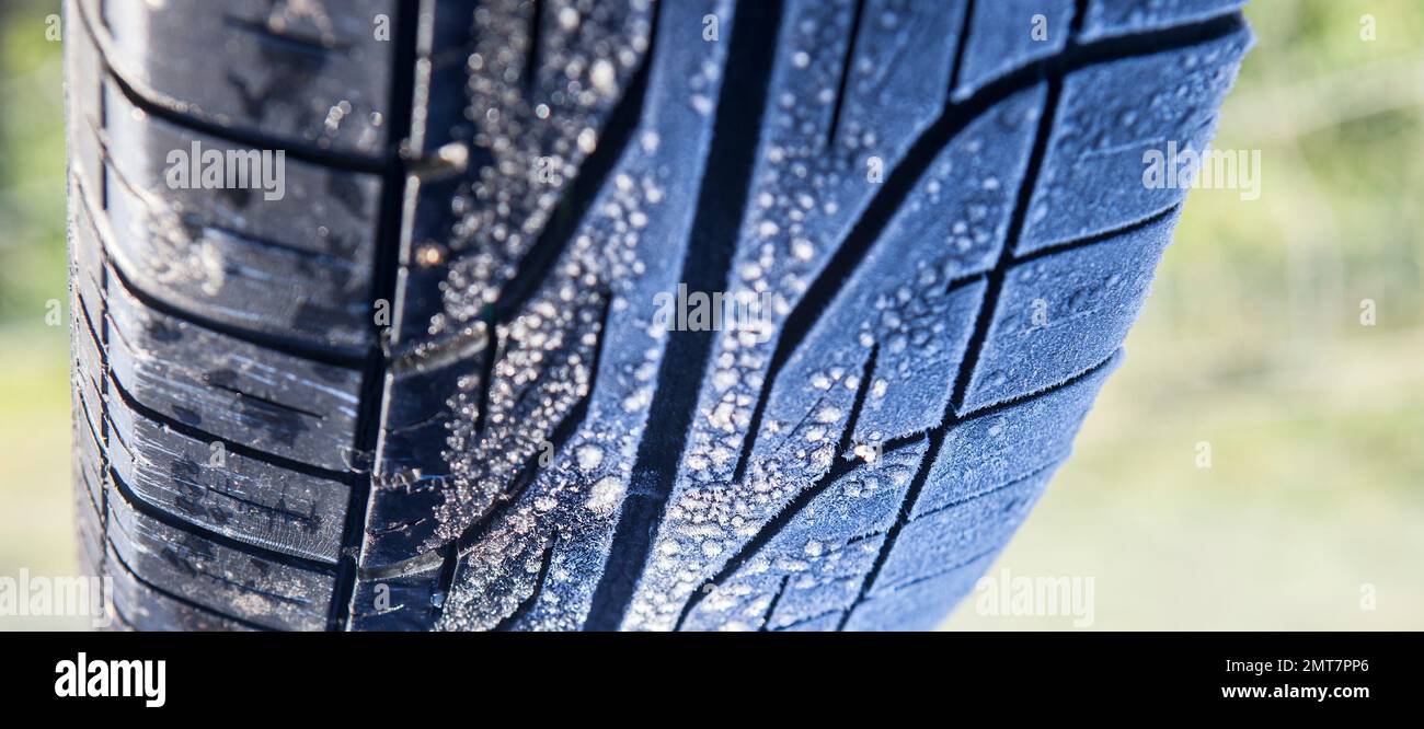 Frost covered tire surface. Safe driving on winter concept Stock Photo