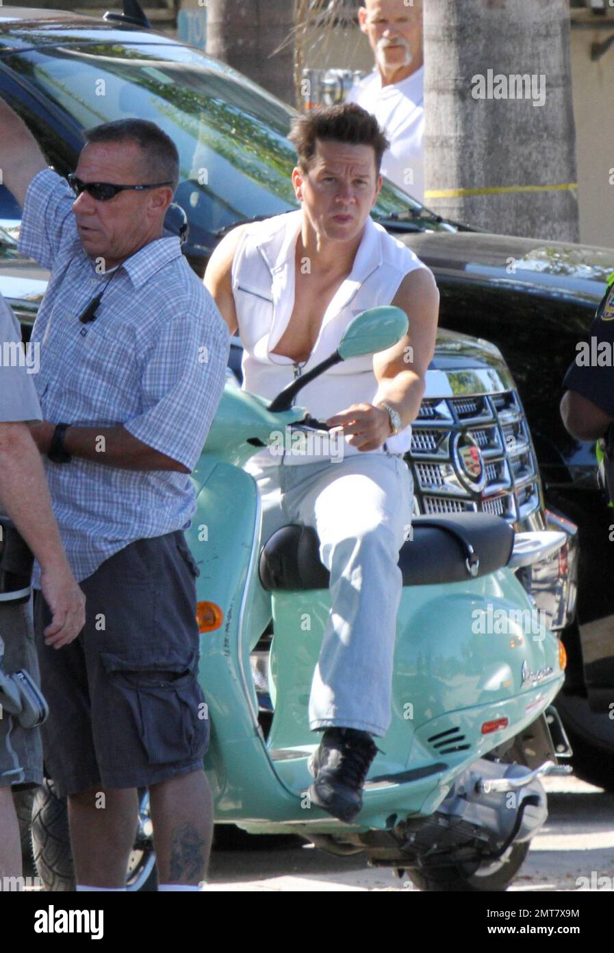 Mark Wahlberg rides a seafoam green Vespa while filming scenes on