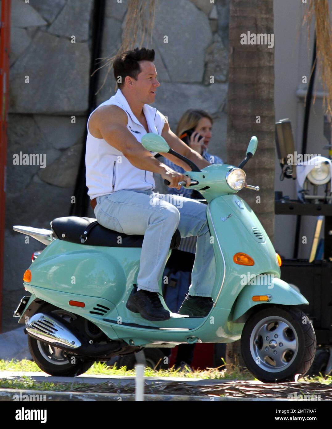 Mark Wahlberg rides a seafoam green Vespa while filming scenes on