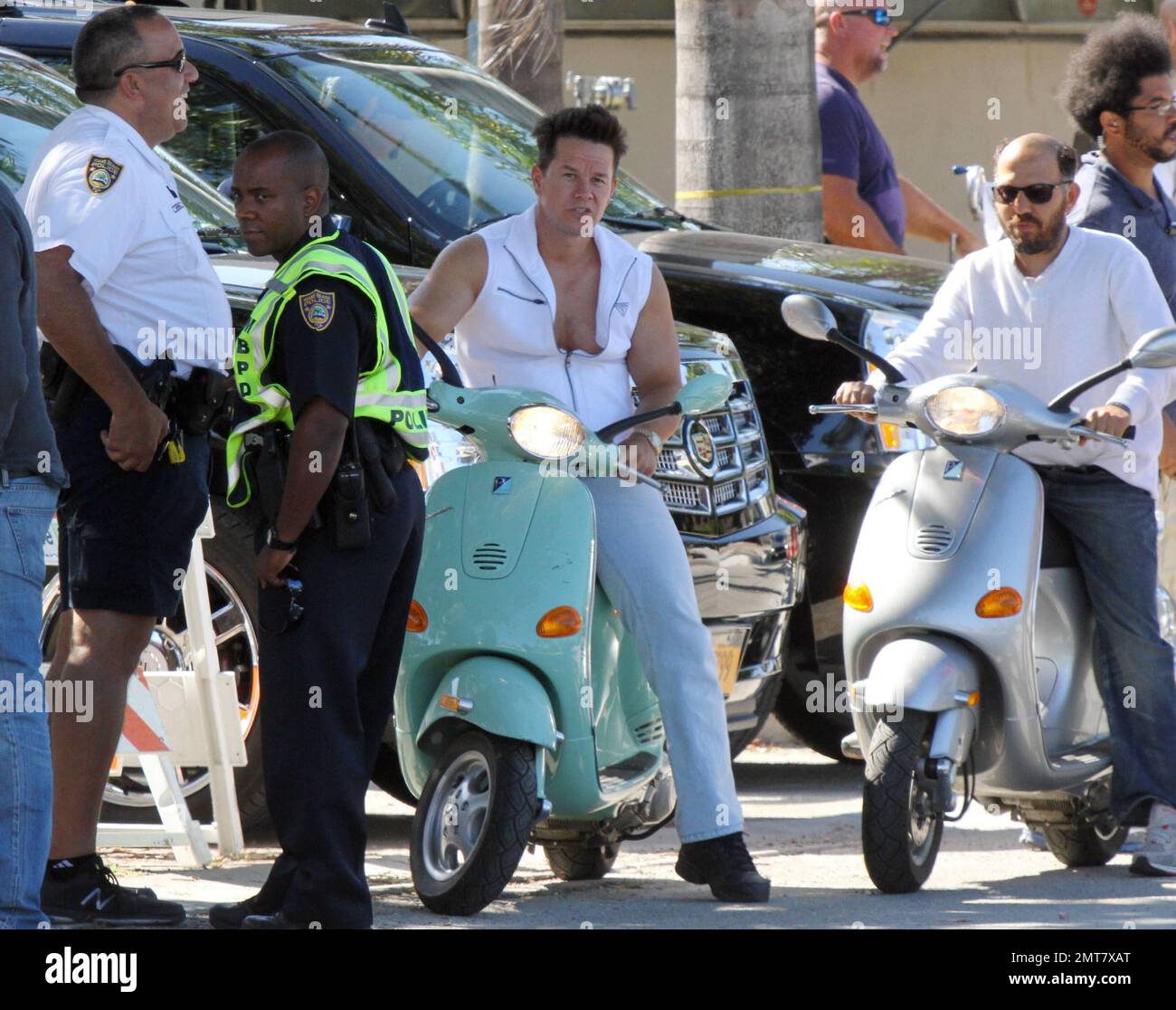 Mark Wahlberg rides a seafoam green Vespa while filming scenes on