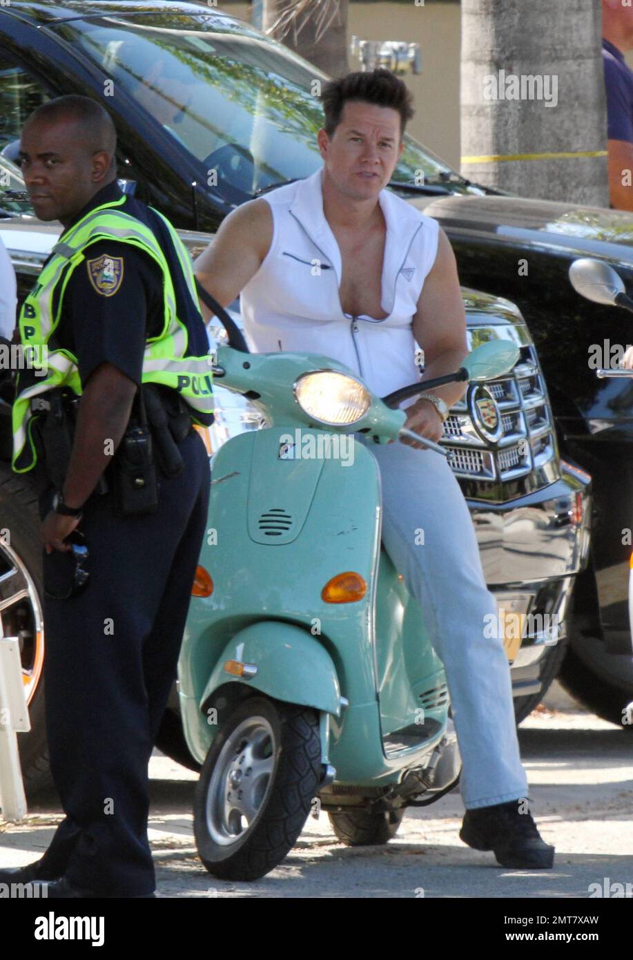 Mark Wahlberg rides a seafoam green Vespa while filming scenes on