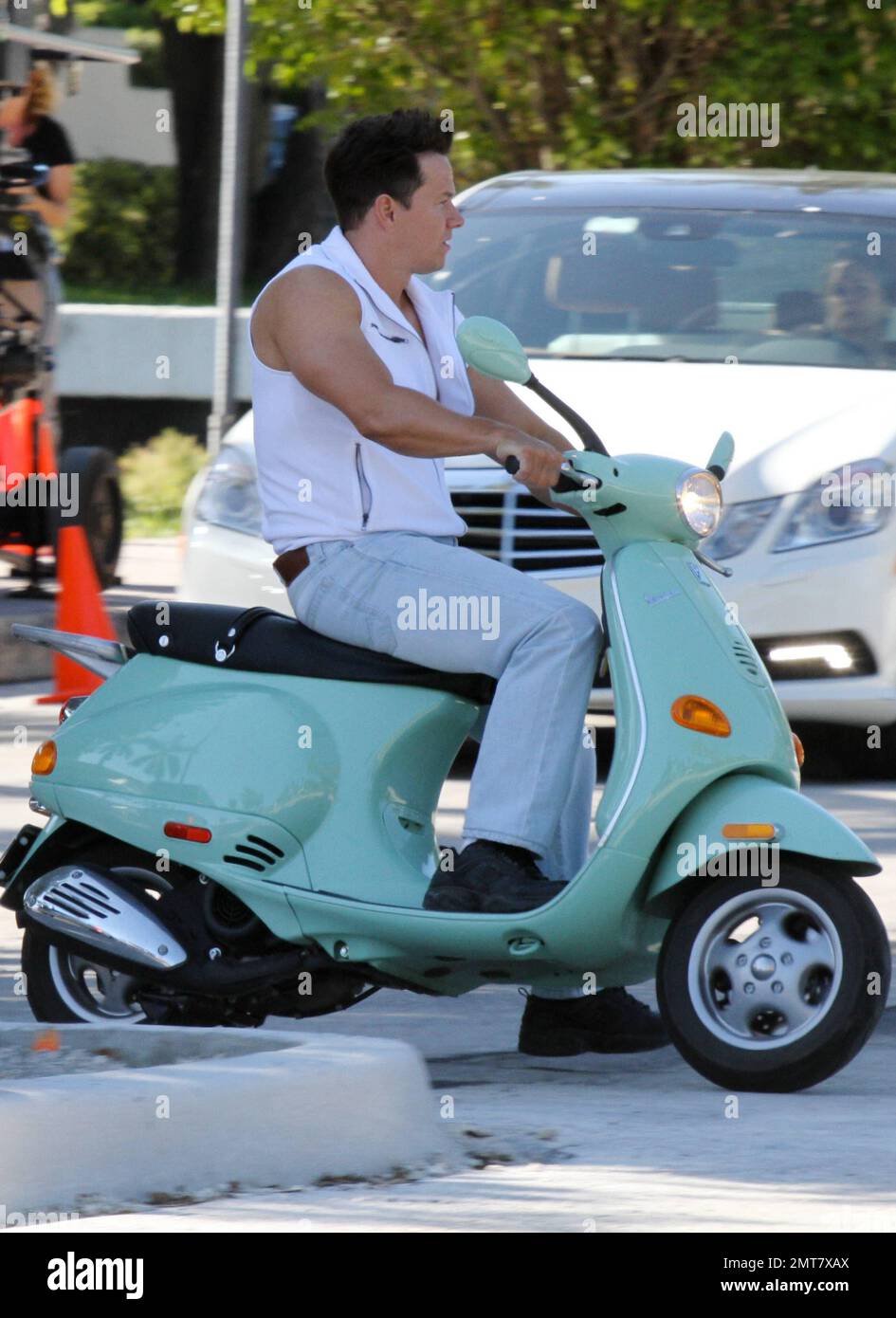 Mark Wahlberg rides a seafoam green Vespa while filming scenes on