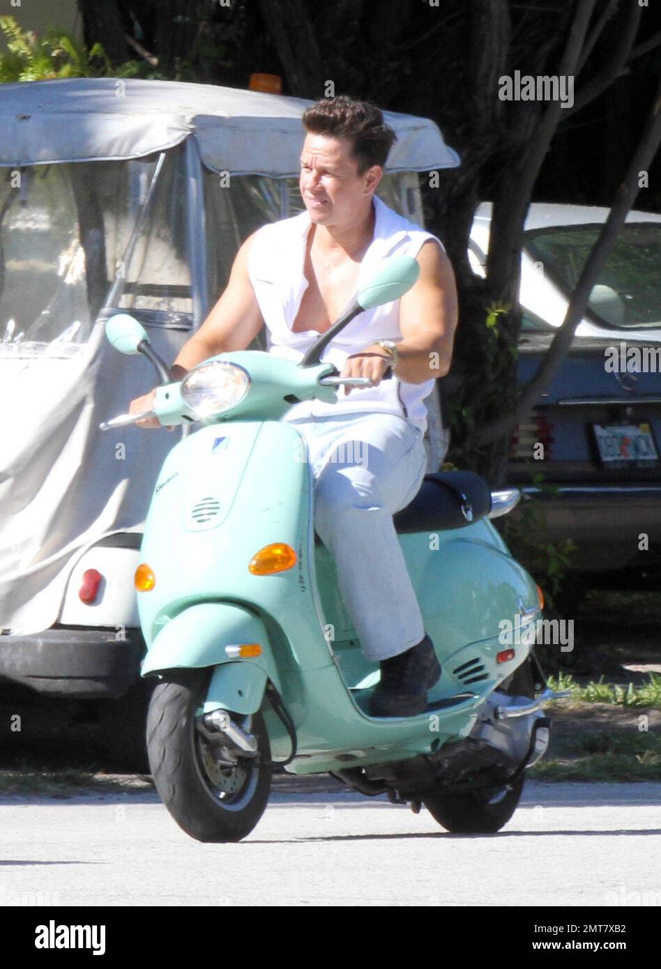 Mark Wahlberg rides a seafoam green Vespa while filming scenes on