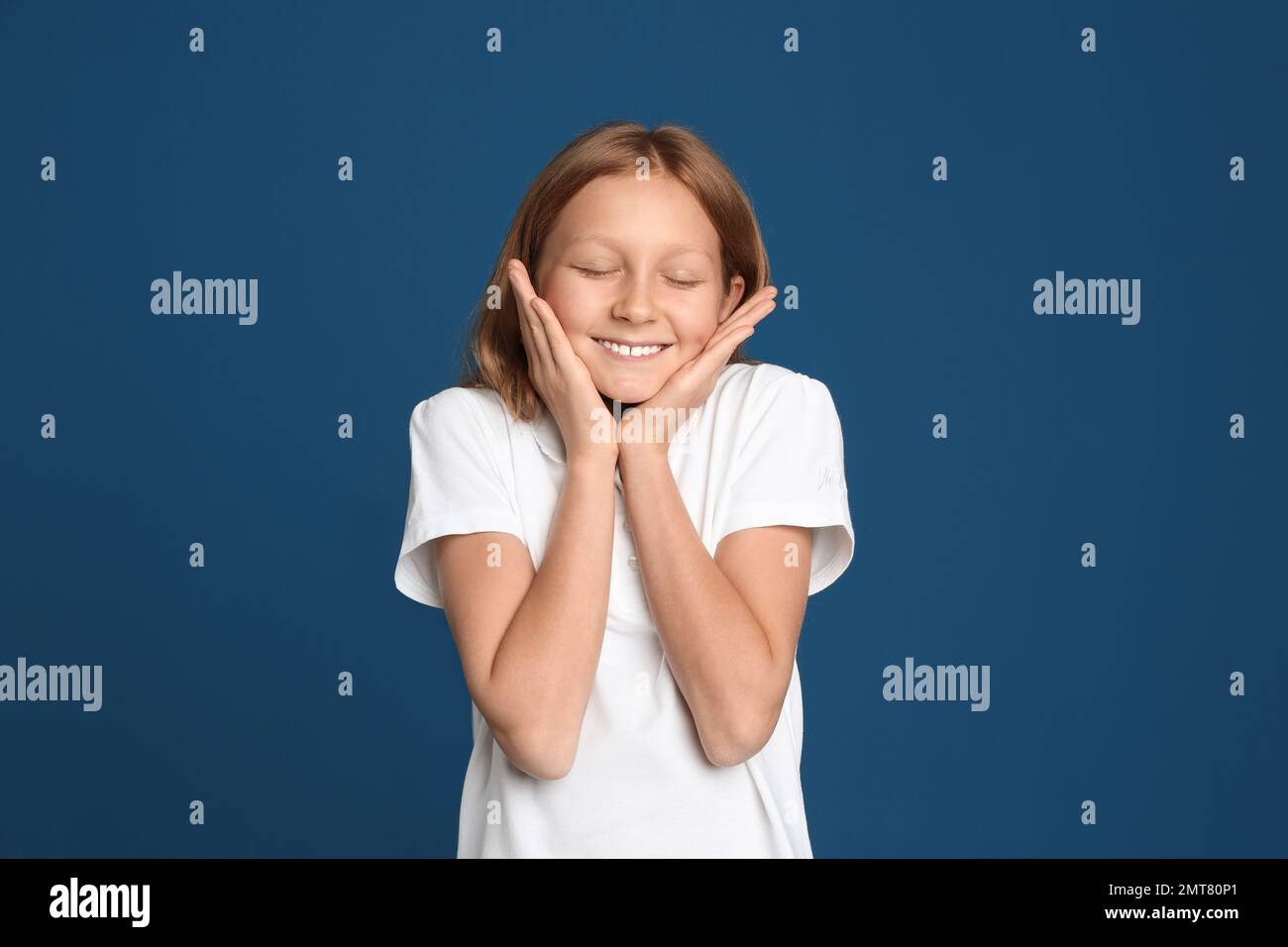Portrait of emotional preteen girl on blue background Stock Photo - Alamy