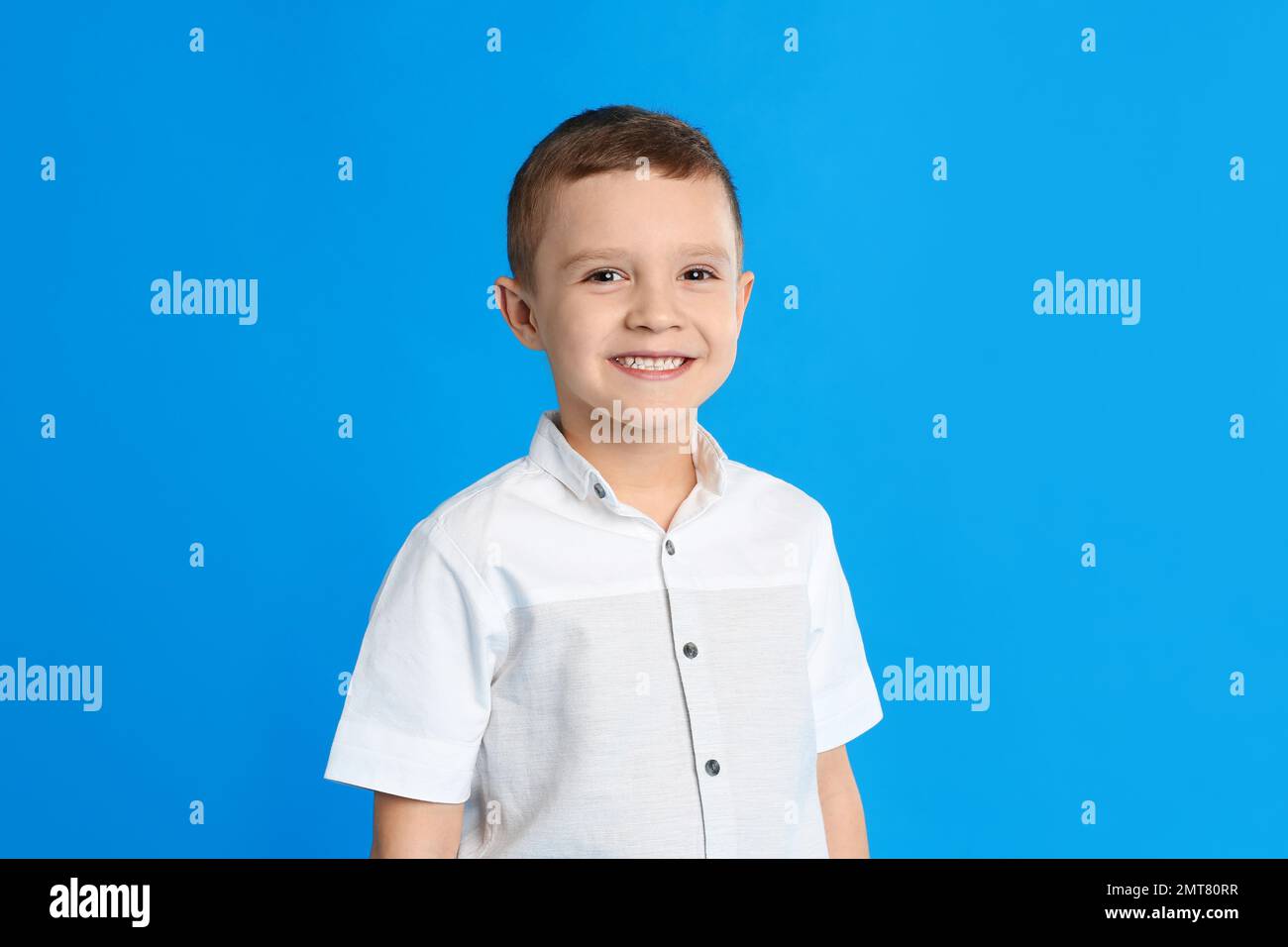 Portrait of cute little boy on blue background Stock Photo - Alamy