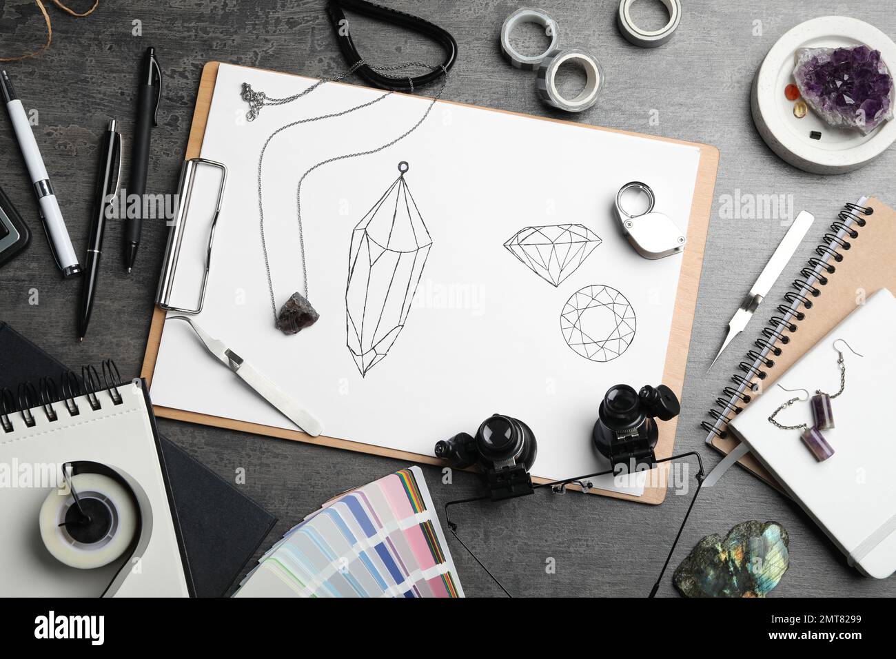 Flat lay composition with drawing of jewelry on grey table. Designer's ...