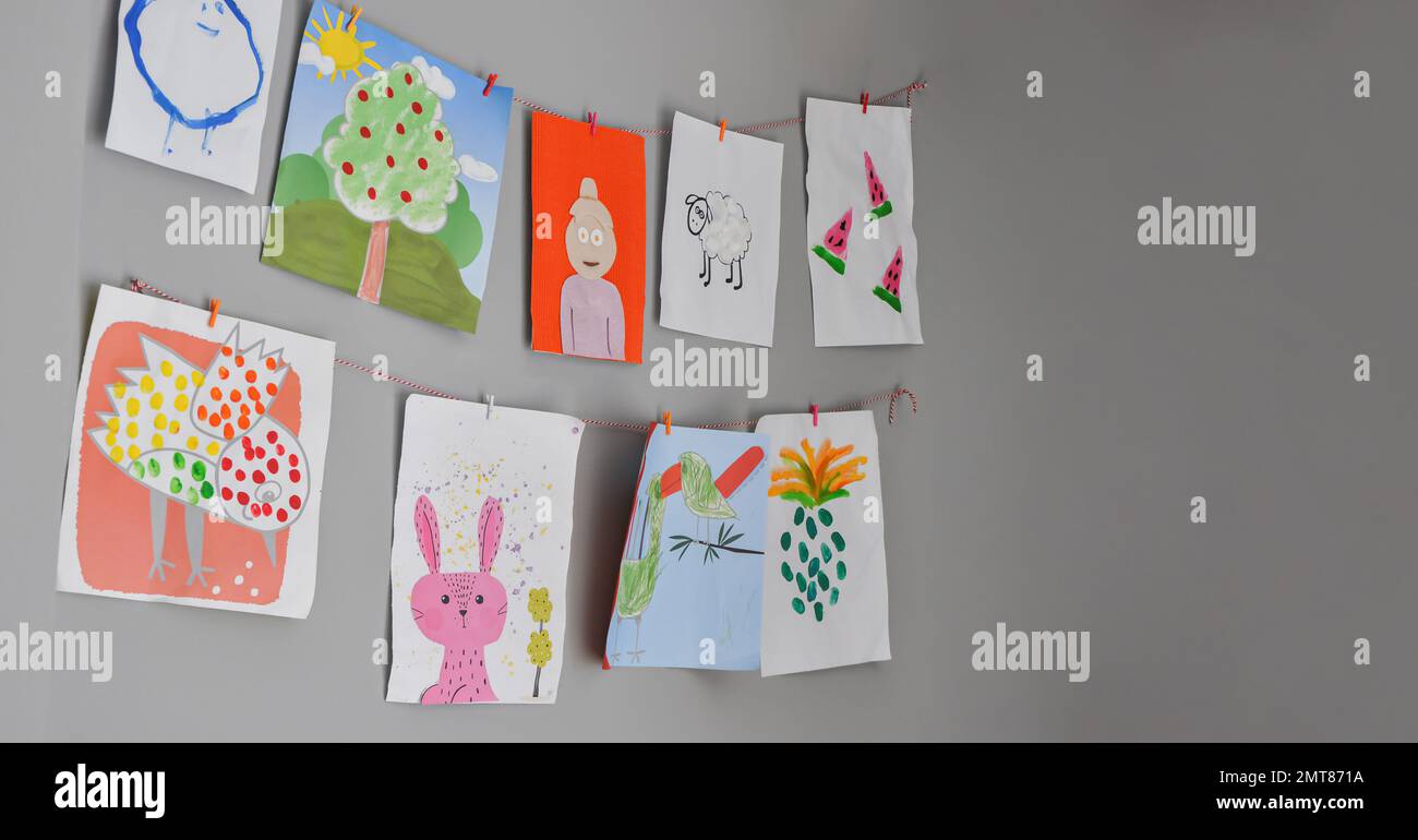 Child drawings hanging on the wall, preschool child painting, kids room, Children's creativity, empty space Stock Photo