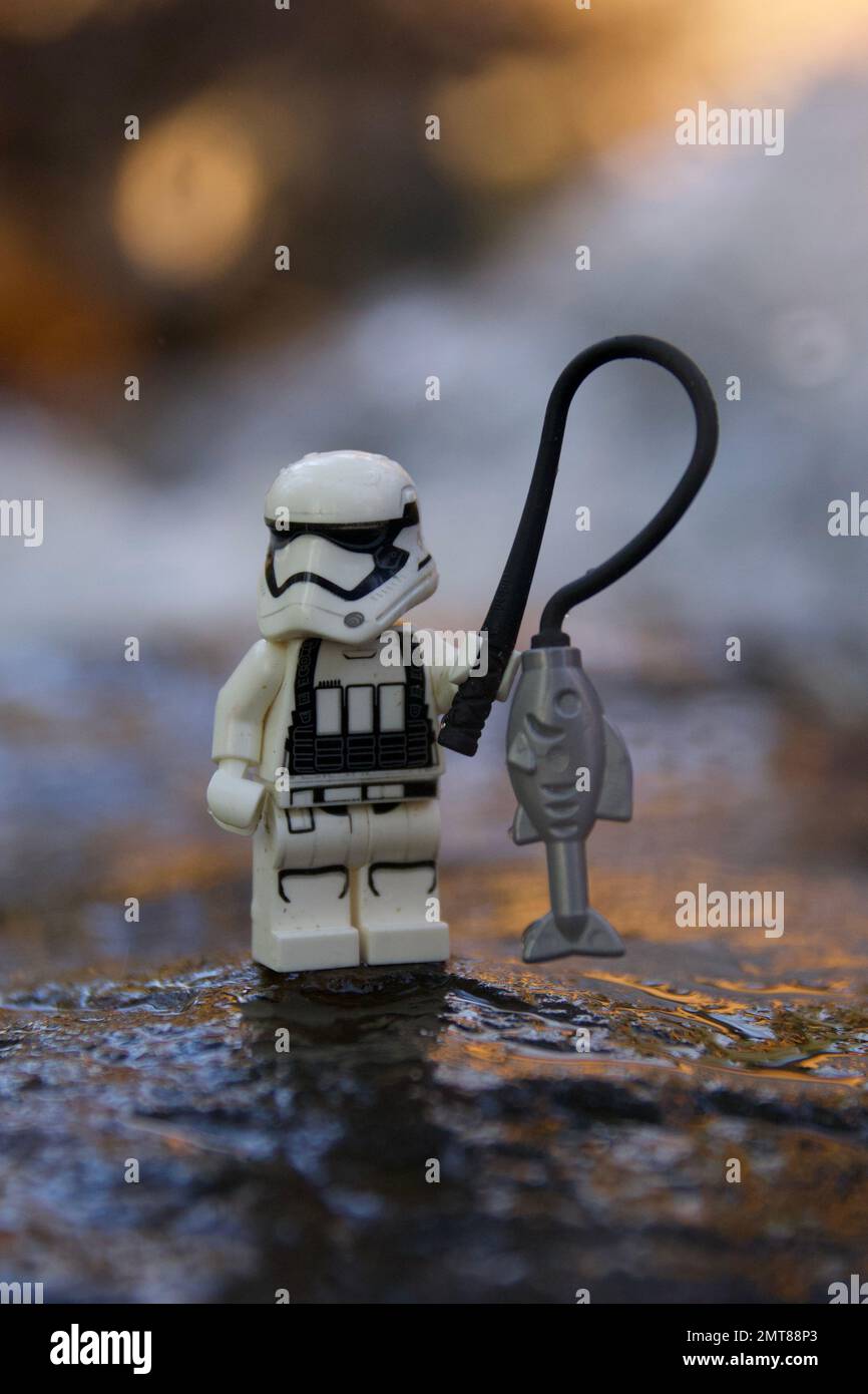 A closeup of a lego stormtroopers toy with a fishing rod on the