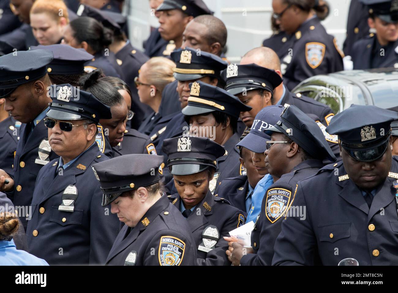 Police officers react as slain police officer Miosotis Familia's