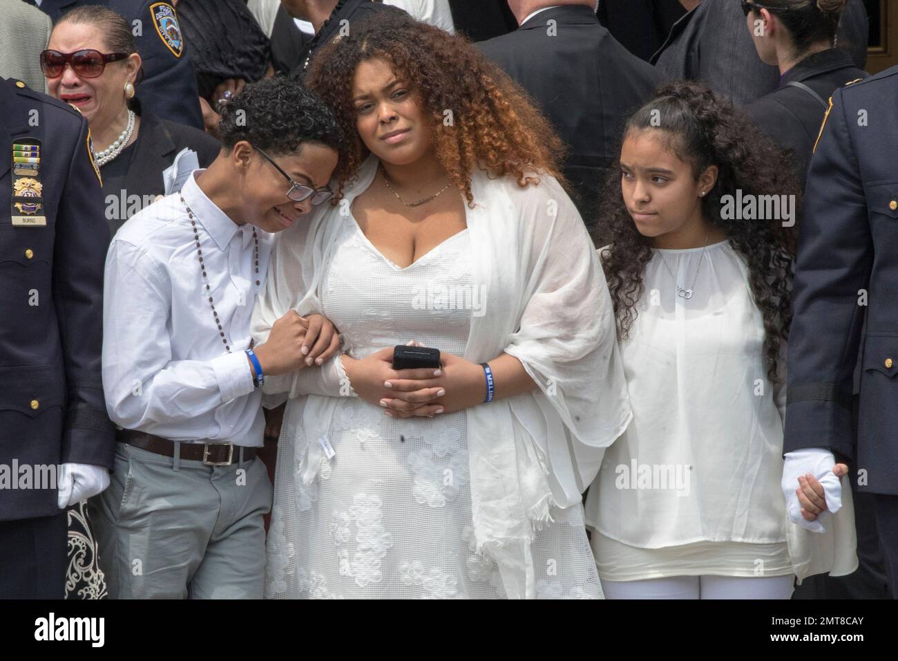 New York City Police officer Miosotis Familia's son Peter, left, and daughter Genesis, center