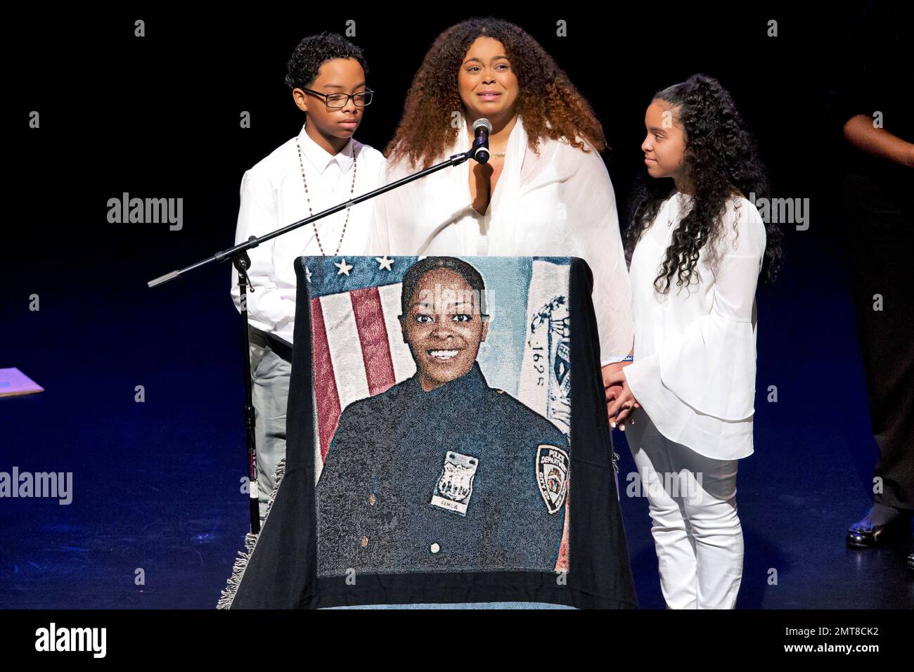 Genesis Villella, center, and twins Delilah and Peter Vega, children of New York City Police