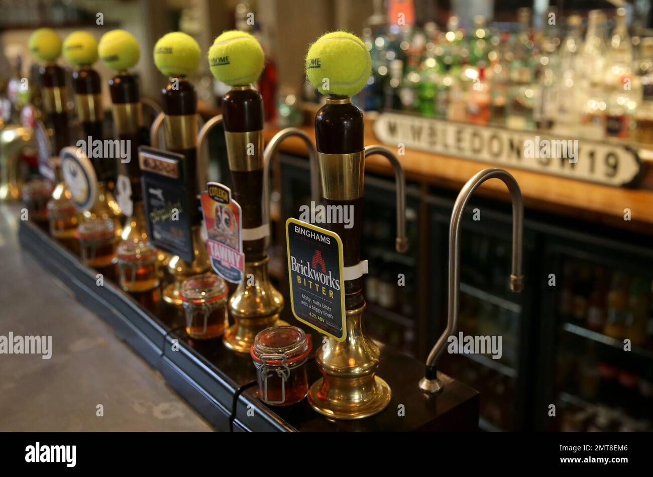 Tennis balls adorn the tops of the beer pumps inside the Hand & Racket ...