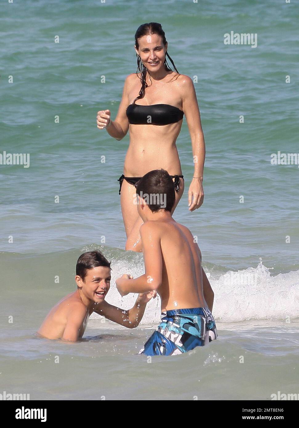 Former soccer player Paolo Maldini along with wife Adriana Fossa and their  sons Christian and Daniel were spotted spending the day at the beach with  friends and family. The group were