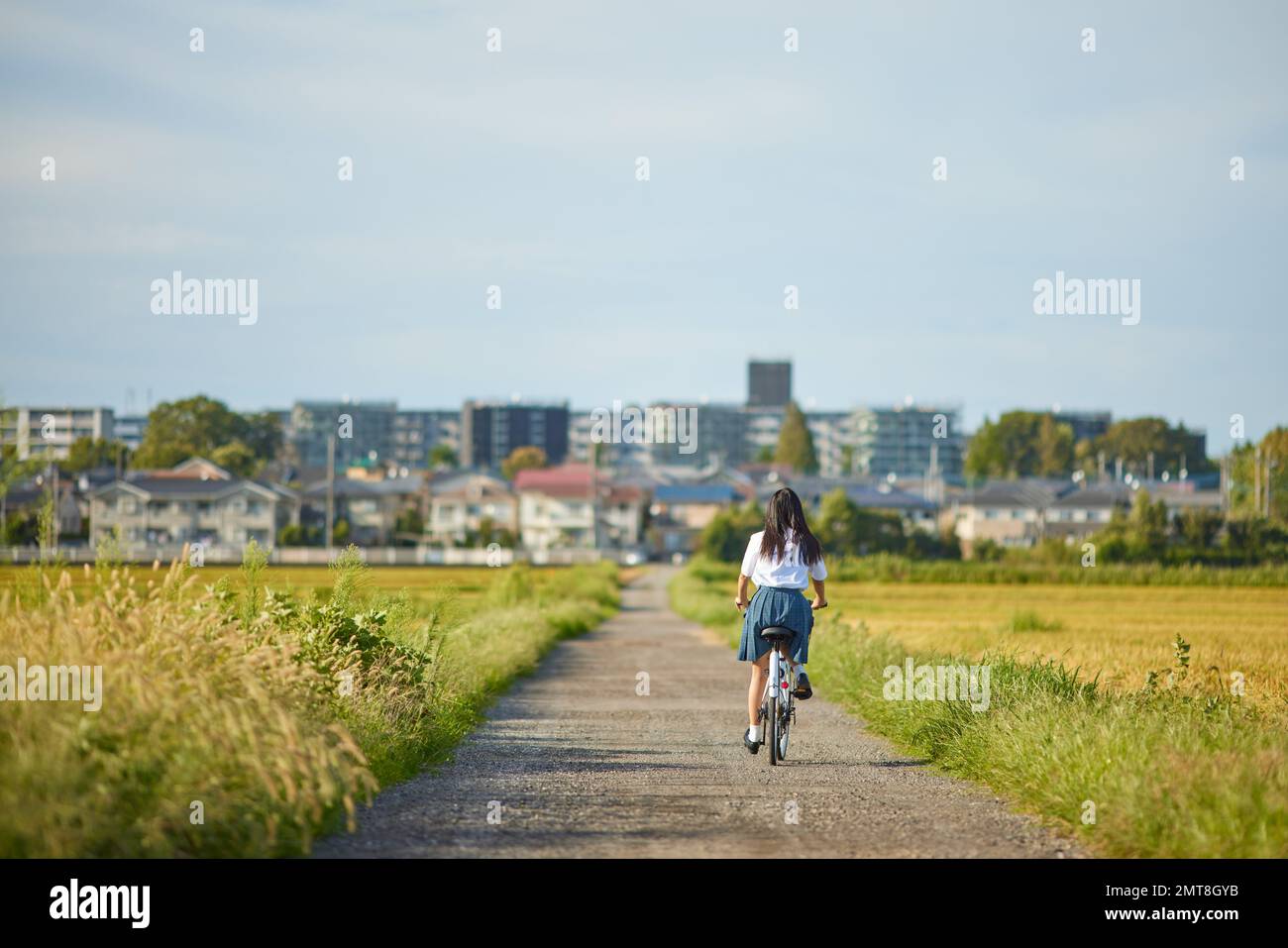 Japanese high school student on a bike outdoors Stock Photo