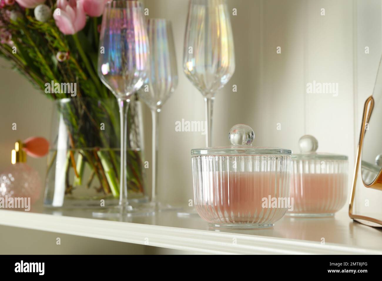 White shelving unit with glassware and different decorative elements