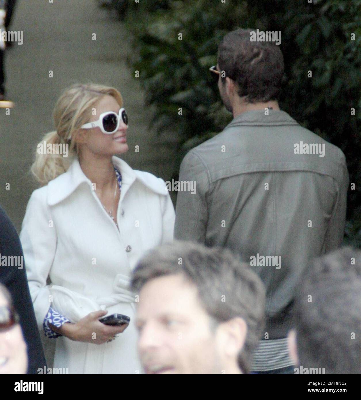 Paris Hilton and beau Stavros Niarchos show some affection as they huddled in a corner waiting for Paris' Bentley to arrive following a pre-Oscars party in Beverly Hills, Ca. The pair held hands and smiled and Paris kept patting Stavros' bottom.  2/24/07 , Stock Photo