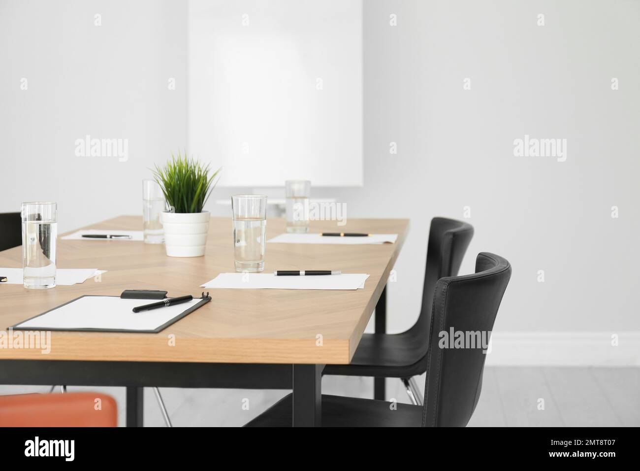 Simple office interior with large table and chairs Stock Photo - Alamy