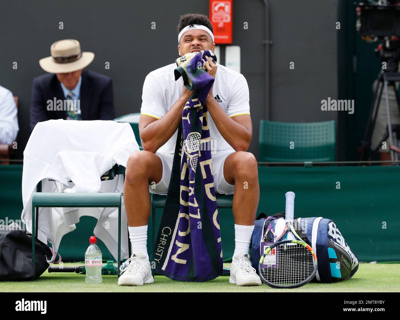 Jo-Wilfried Tsonga of France wipes his face as he prepares to resume his  match with Sam Querrey of the United States during their Men's Singles  Match on day six at the Wimbledon