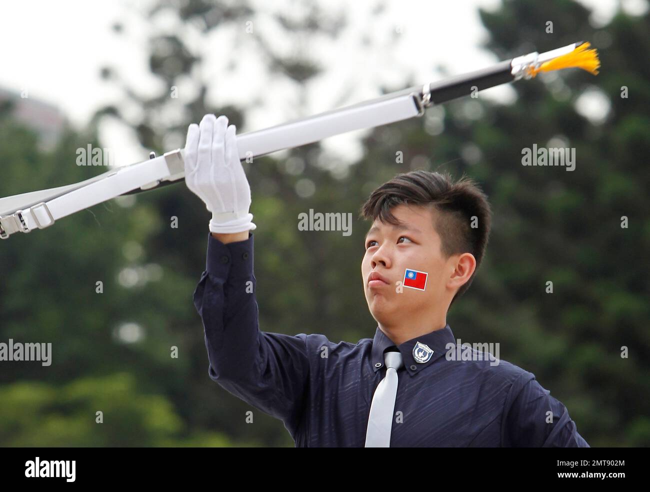 A senior high school student performs during the military honor guard ...